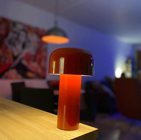 Cordless USB Rechargeable Desk Lamp With Touch Dimming in red on tabletop with living room background