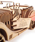 Roadster 3D Wooden Car Kit For Adults, DIY Mechanical Model With Transmission, Plywood Build, Real Working Gear System, Hands-On STEM Toy, Perfect Gift For Car Enthusiasts And Builders, Vintage Style Craft Project shown close-up, hand opening side door