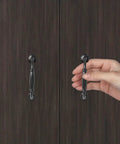 Black Cabinet Handles Set, 3 3/4 Inch Hole Center (96mm), being installed on dark wooden cabinet door.