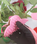 Gloved hand using plastic rose thorn remover from Rose Thorn Stripper Tool Kit For Garden Pruning Shears And Scissors with Gloves