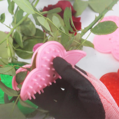 Gloved hand using plastic rose thorn remover from Rose Thorn Stripper Tool Kit For Garden Pruning Shears And Scissors with Gloves