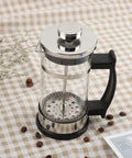 French Press Coffee Maker With Ergonomic Handle, Food Grade Stainless Steel Turkish Coffee Pot And Espresso Brewer on table