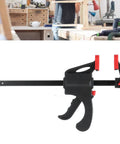Dead Serious Six Inch Woodworking Bar Clamp With Long Rod Frame for tight corners displayed on a workbench in a workshop setting.