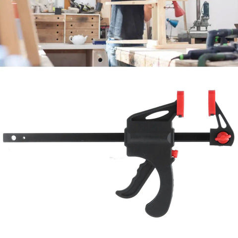 Dead Serious Six Inch Woodworking Bar Clamp With Long Rod Frame for tight corners displayed on a workbench in a workshop setting.