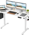 Electric Standing Desk With Four Memory Presets And No Sweat Height Adjustment In White, Ergonomic Sit Stand Office Table with dual monitors and laptop.