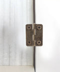 Small Iron Hidden Hinges Pack For Jewelry Boxes Bird Houses And Small Drawers installed on wood surface with screws visible