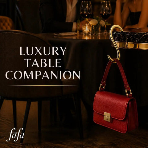 Gold Finish 22K Purse Hook For Table, Heart Shaped Portable Handbag Holder used in a luxury dining setting.