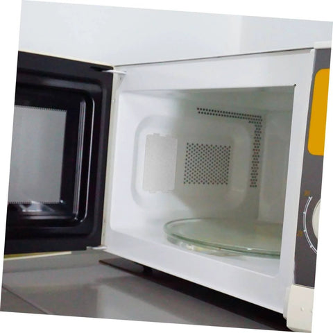 Open microwave showing installed mica plate insulation sheets for microwave oven heat resistant kitchen mats