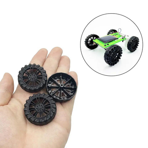 30Pcs Plastic Toy Car Wheels With 2mm Shafts And 15Pcs Round Rod Axles For RC Cars Trucks Robots DIY Model Parts Black, shown in hand