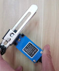 Hands holding Two Pack ME 8108 Momentary Limit Switch with Rotary Adjustable Roller Lever Arm, ideal for CNC mills and Arduino projects.
