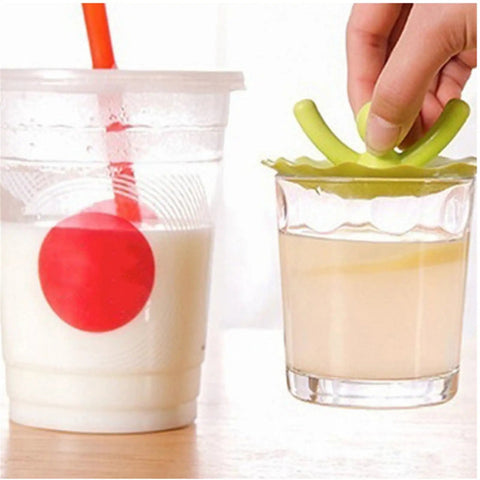 Shape Floor Drain Plug, Shower Bathtub Drain Covers, Green on a glass with a colorful drink and straw next to a cup.