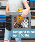Person lifting Heavy Duty Collapsible Milk Crate 25L Six Point Six Gal with gloves inside, designed to hold 50 lbs, obsidian black.