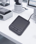 Industrial Touchpad Mouse Panel Mount Controller With Wired USB Plug And Play Control Unit And Rectangular Housing For Tight Space Installations, Mounting Profile Ready, Flexible Coiled Cable, black panel-mounted touchpad on lab bench