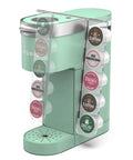 Keurig K Mini Cup Organizer Holder Holds 10 Pods Space Saving Acrylic Rack For Single Serve Coffee Makers Fits K Mini And K Mini Plus Keeps Counter Clean And Tidy On Countertop next to green coffee maker