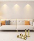 Top Shelf Gold Adjustable Metal Sofa Legs For Couches And Tables Flat Out Durable Heavy Duty Furniture Feet on a stylish couch.