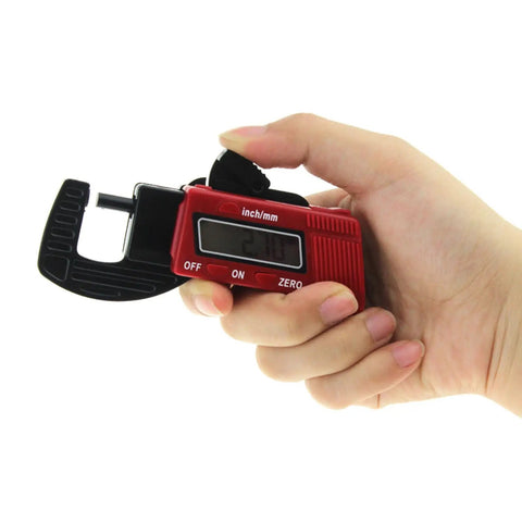 Person holding a digital caliper with LCD for measuring metal and plastic, part of a Two Pack Digital Thickness Gauge Caliper Micrometer For Precise Measurement Of Metal And Plastic Thickness Portable Easy Readout On The Go Industrial Automotive Grade Tool Set