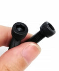 Hex Socket Cap Head Screws and Nuts Kit in Black Grade 12.9 Steel DIN912 M1.6 To M8 Includes Driver Bits Boxed Set with 1200 M1.6 Screws 400 M2 400 M2.5 400 M3 Nuts and Washers Heavy Duty DIY Garage Projects, close-up of black hex socket cap screws