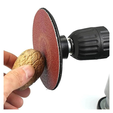 25 Piece Hook And Loop Sanding Discs Assortment Featuring 40 To 3000 Grit Sizes on a drill with a walnut for polishing surfaces.