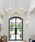 Gold 6 Light Candle Chandelier With Dope Modern Brass Farmhouse Vibe Wrought Iron Ceiling Pendant Light Fixture in an entryway