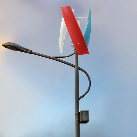 Vertical axis wind turbine with three blades in red, white and blue atop a metal pole.