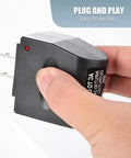 Zero Hassle Wall To Ride Power Adapter Runs Your Car Gadgets Indoors, hand holding black AC to DC adapter with plug.