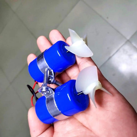 Hand holding blue Beefy 7.4V RC Jet Boat Underwater Thruster 16800 RPM CW CCW 3 blade propeller for DIY micro ROV submarine.