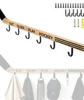 Premium Quality Top Tier Solid Wood Hockey Stick Wall Mounted Coat Rack Featuring Six Heavy Duty Hooks displayed with hats and gear.