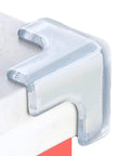 Ultra Clear Silicone Corner Protectors For Baby Proofing T Shaped Furniture Edge Guards With A Rock Solid Grip Four Pack on a table corner.