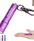 Ultra Bright Keychain LED Flashlight For EDC, tiny purple pocket torch on hand with AAA battery, durable clip, everyday carry