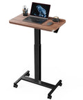 Mobile Standing Desk With Wide Height Range From 28.5 To 46.1 Inches, Adjustable Sit Stand Computer Desk On Four Lockable Wheels, Perfect For Home Office And Classroom, Walnut Finish with laptop and mug on top