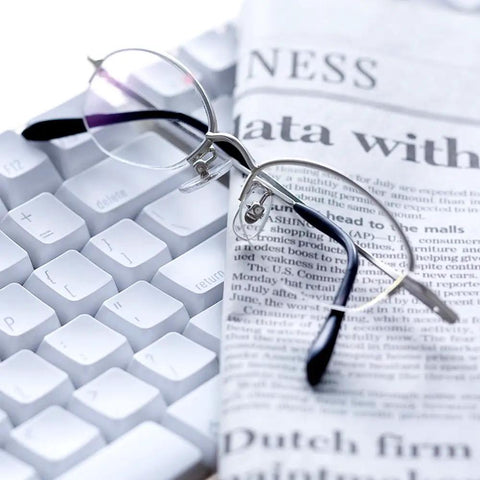 Complete Eyeglass Repair Kit Featuring 1500 Micro Screws And Nose Pads For Glasses Sunglasses And Prescription Frames on a desk with newspaper and keyboard.