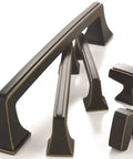 Collection of various appliance pulls and knobs in satin nickel, showcasing beefy satin nickel 12 inch center to center appliance pull for paneled appliances and large cabinets Mulholland style drawer pull traditional cabinet hardware with a long thirteen and three sixteenths inch overall length.