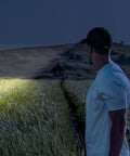 Man using 10 Pack Dope Mini Pocket Flashlights With Clip Penlight Style Tactical Beams for nighttime adventure.