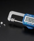 Digital Thickness Gauge 0-25mm, Electronic Vernier Caliper, 0.01mm Precision measuring a gemstone at 9.25mm.