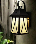 Dope Outdoor Wall Lantern 120V With Dusk To Dawn Photocell on wall, oil rubbed bronze finish, lit with LED bulb.