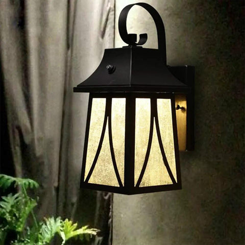 Dope Outdoor Wall Lantern 120V With Dusk To Dawn Photocell on wall, oil rubbed bronze finish, lit with LED bulb.
