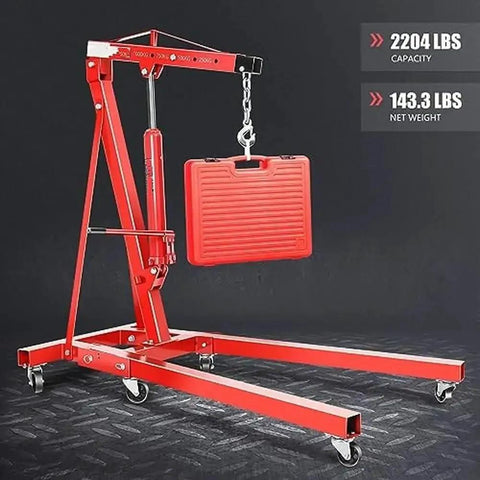 Foldable Hydraulic Engine Hoist Crane With Swivel Casters And Four Position Boom heavy duty shop lifter raising a toolbox, 2204 lbs capacity.