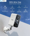 Wireless Outdoor Security Cameras 2 Pack, No Wires Needed 2K WiFi Surveillance System mounted on wall in sunny outdoor setting.