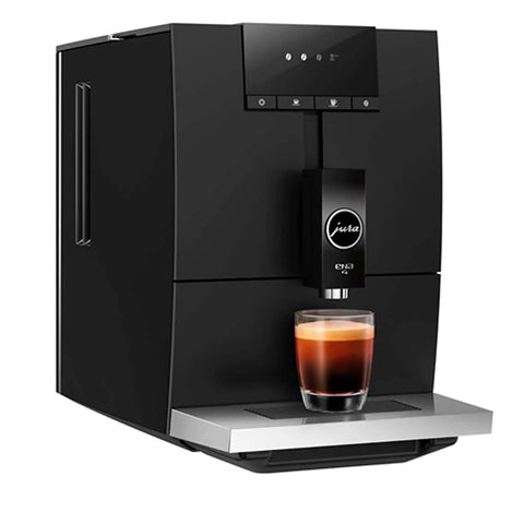 One Touch Fully Automatic Black Coffee Maker Ena Model with brewed coffee in glass, matte black finish and sleek design.