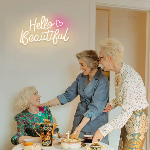 Hello Beautiful Neon Sign For Girl's Room Wall Decor With Dimmer Switch Romantic Neon Light For Weddings Valentine's Day Parties Gifts 12V Warm White With Power Adapter Included glowing on wall above three women seated at table