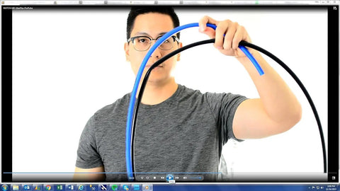 Man holding a blue and black Kink Resistant Pressure Washer Hose One Quarter Inch 3100 PSI 50 Feet Made In USA Flexible ProPulse Tech