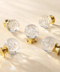Crystal Bubble Ball Cabinet Knobs 12 Pack Dope Transparent Sphere Handles With Gold Aluminum Base on beige surface