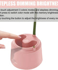 Hand demonstrating touch-sensitive switch on pink Cute LED Desk Lamp With Flower And Bird Design USB rechargeable base.