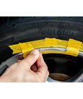 Applying liquid aluminum compound from Solid Alloy Wheel Repair Kit For Black Rims to fix curb rash on alloy wheel.