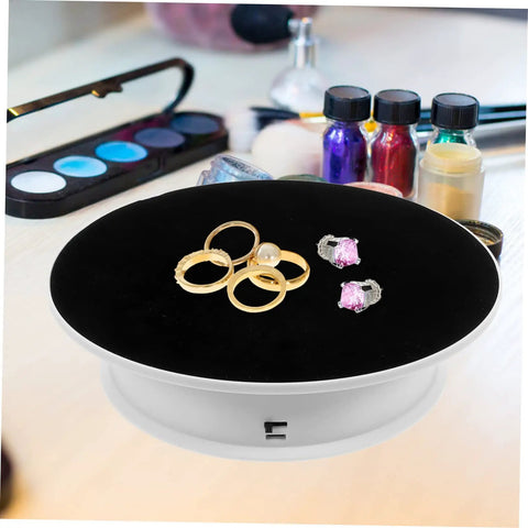 Premium Rotating Jewelry Display Stand With Smooth Electric Turntable Spin For Selling Accessories And Cosmetics with rings on black velvet.