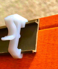 Close-up of Sturdy White Plastic Valance Clips For Mini Window Blinds, 1 Inch Hidden Rod Holders in use.