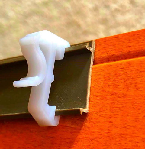 Close-up of Sturdy White Plastic Valance Clips For Mini Window Blinds, 1 Inch Hidden Rod Holders in use.