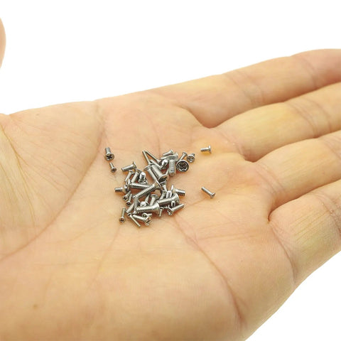 Hand holding assorted Handy 750 Piece Metric Stainless Steel Phillips Flat Head Machine Screws Assortment Kit for DIY projects