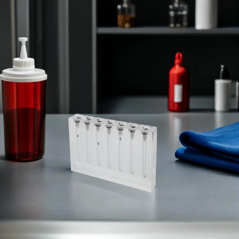 Engine Oil Quality Tester And Flow Comparator Tool With 7 Hole Acrylic Plate For Visual Oil Assessment Kit on table, acrylic plate, red oil bottle