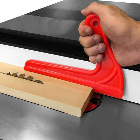 Hand using 4 Pack Safety Push Sticks for Table Saw and Woodworking, red ABS V style push stick guiding wood on table saw
